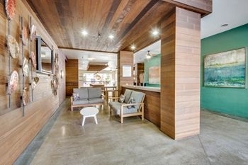 A living room with a wooden floor and a green wall.